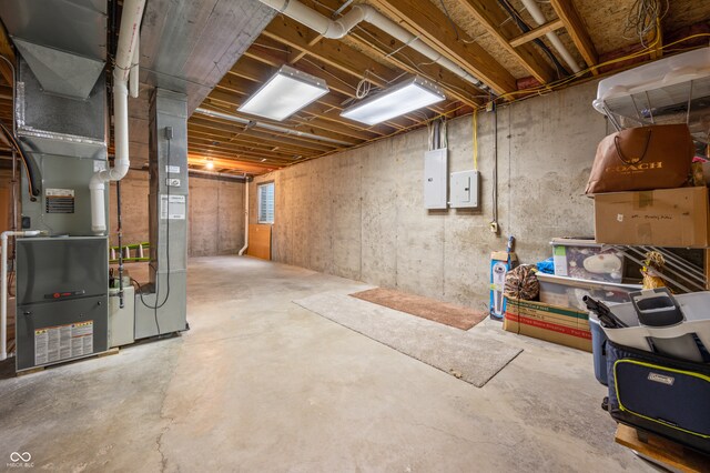 basement featuring heating unit and electric panel