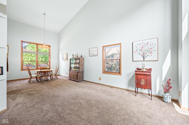 1936 Broadmoor Ln, Columbus, IN 47203 - dining area featuring high vaulted ceiling, carpet flooring, baseboards, and a chandelier