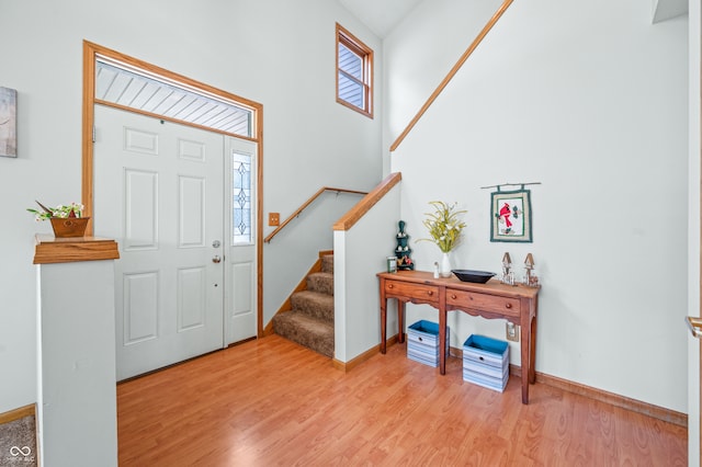 entrance foyer featuring a high ceiling and light hardwood / wood-style flooring