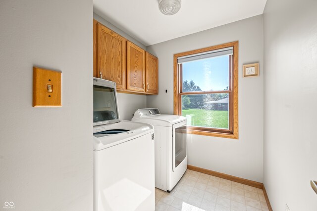 laundry area featuring washing machine and dryer and cabinets