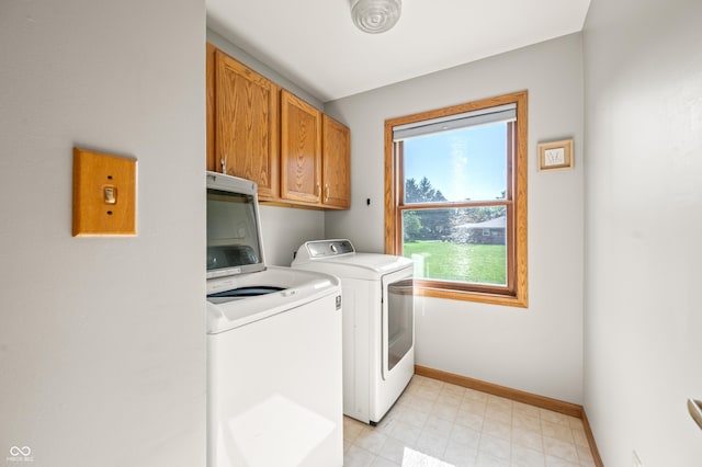 1936 Broadmoor Ln, Columbus, IN 47203 - laundry room featuring independent washer and dryer, cabinet space, and baseboards