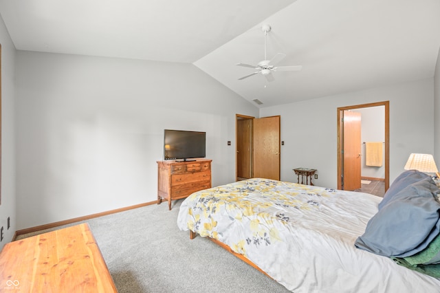 bedroom with ceiling fan, carpet, lofted ceiling, and ensuite bath