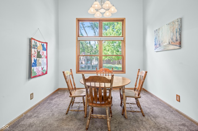 carpeted dining room with an inviting chandelier