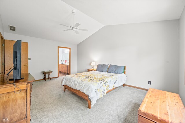 bedroom featuring lofted ceiling, ensuite bathroom, carpet, and ceiling fan