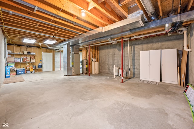 basement featuring water heater and heating unit