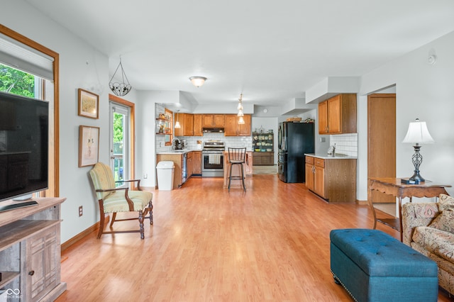 living room featuring sink and light hardwood / wood-style floors