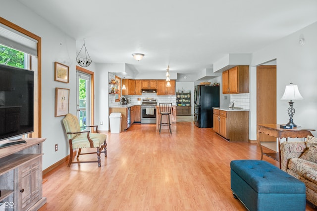 1936 Broadmoor Ln, Columbus, IN 47203 - living area with healthy amount of natural light, light wood-style flooring, and baseboards