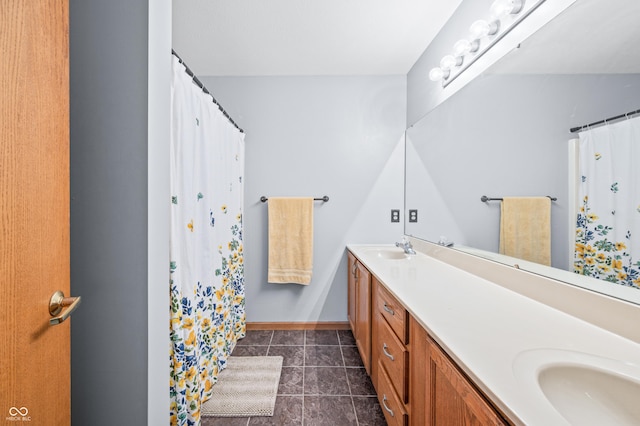 1936 Broadmoor Ln, Columbus, IN 47203 - full bathroom featuring double vanity, tile patterned flooring, baseboards, and a shower with shower curtain
