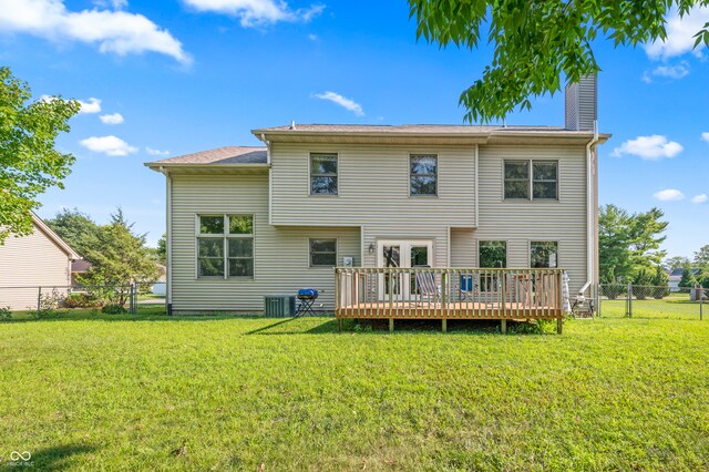 back of property featuring central AC, a deck, and a yard