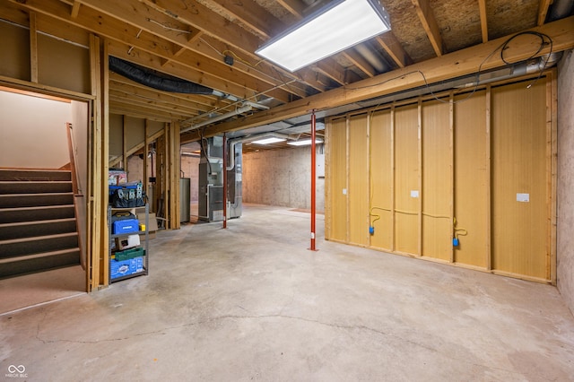 1936 Broadmoor Ln, Columbus, IN 47203 - unfinished below grade area with water heater, heating unit, and stairway