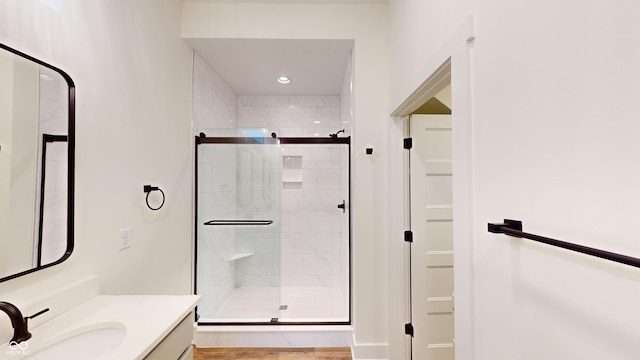 bathroom with an enclosed shower and vanity