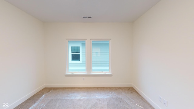 spare room with light carpet