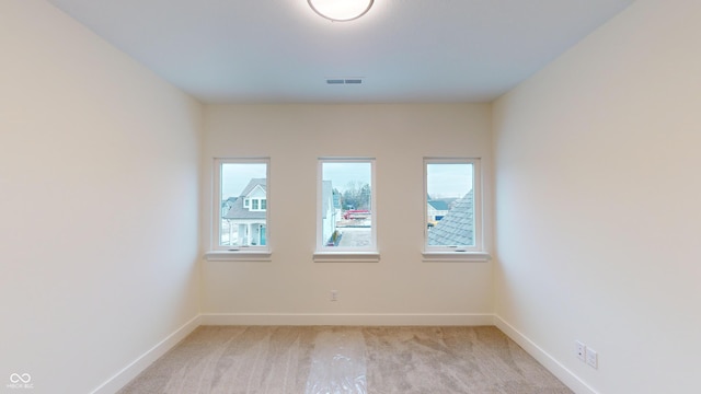 empty room with light colored carpet