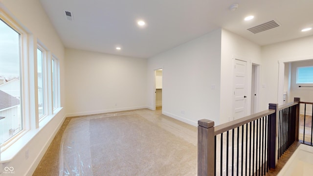 hallway featuring light carpet