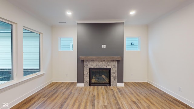 unfurnished living room featuring a fireplace and light hardwood / wood-style floors