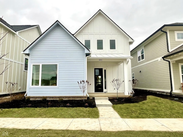 modern inspired farmhouse with a front lawn