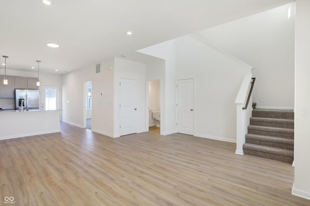 unfurnished living room featuring light hardwood / wood-style flooring