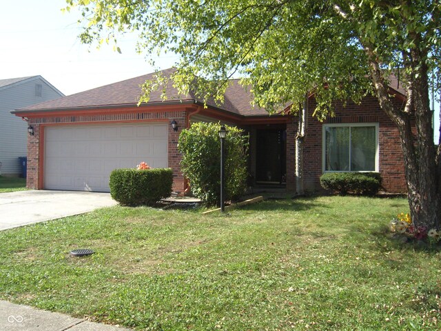 view of front facade with a front lawn and a garage