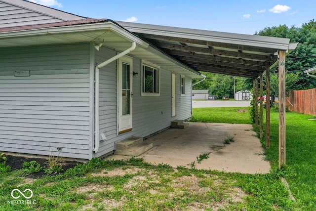 view of property exterior featuring a carport and a yard