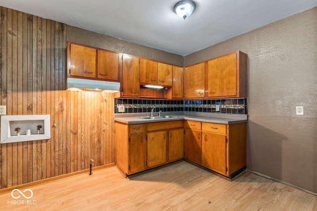 kitchen featuring light hardwood / wood-style flooring, sink, and decorative backsplash