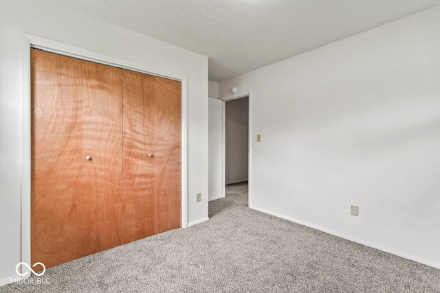 unfurnished bedroom with carpet flooring and a closet