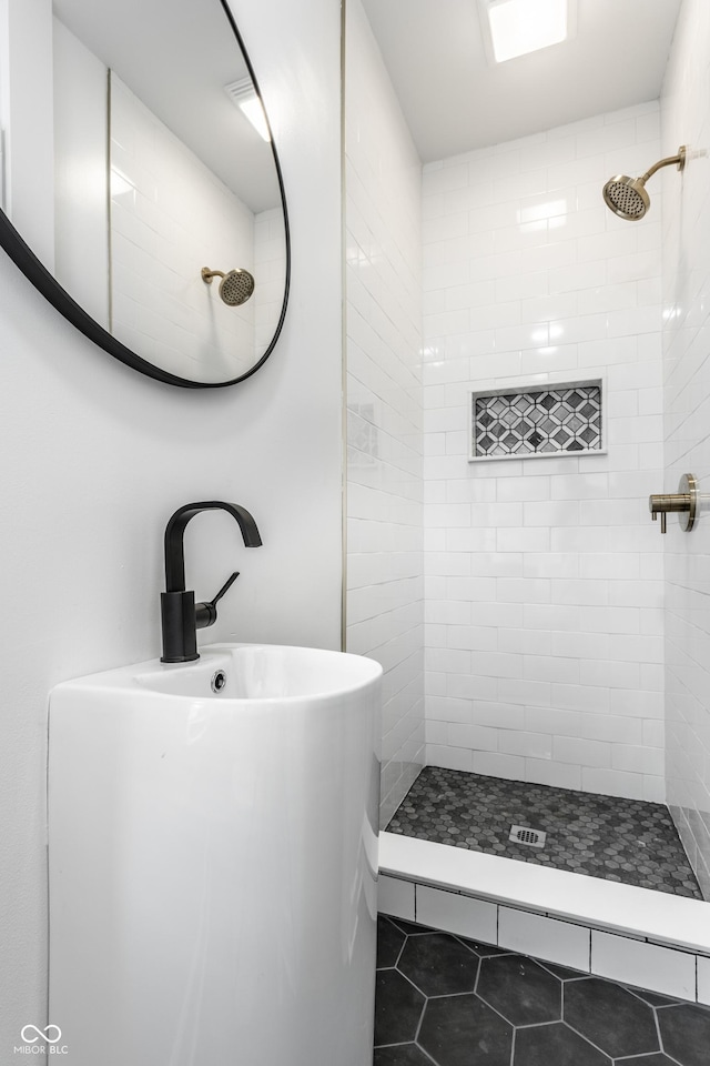 1210 Finley Ave, Indianapolis, IN 46203 - bathroom featuring tiled shower, tile patterned flooring, and a sink
