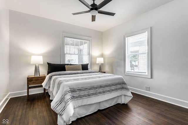 1210 Finley Ave, Indianapolis, IN 46203 - bedroom with baseboards, multiple windows, and wood-type flooring