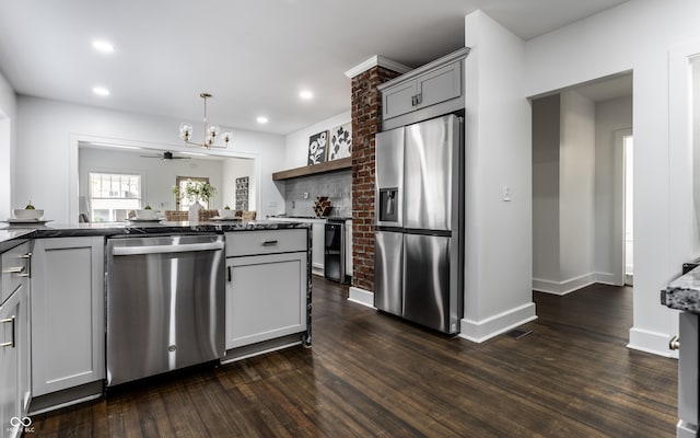 1210 Finley Ave, Indianapolis, IN 46203 - kitchen with stainless steel appliances, dark wood finished floors, a chandelier, recessed lighting, and decorative light fixtures