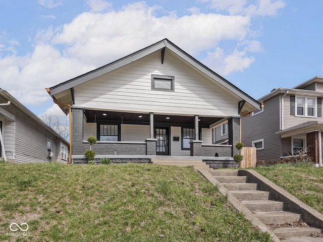 1210 Finley Ave, Indianapolis, IN 46203 - view of front of home featuring covered porch and a front lawn