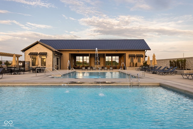 view of swimming pool featuring a patio and pool water feature