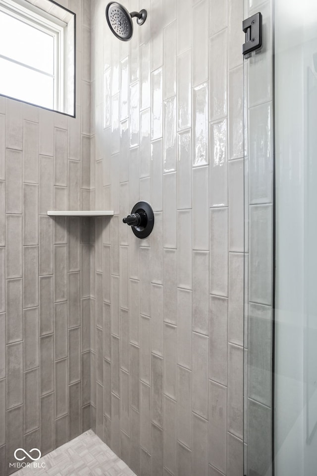 bathroom with a tile shower