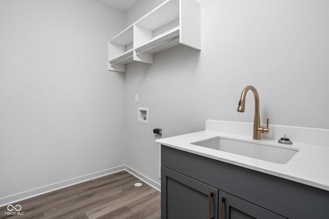 laundry room with cabinets, sink, dark hardwood / wood-style flooring, and hookup for a washing machine