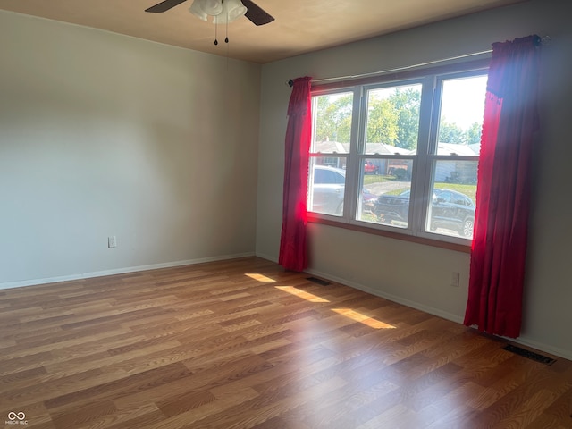 spare room with wood-type flooring and ceiling fan