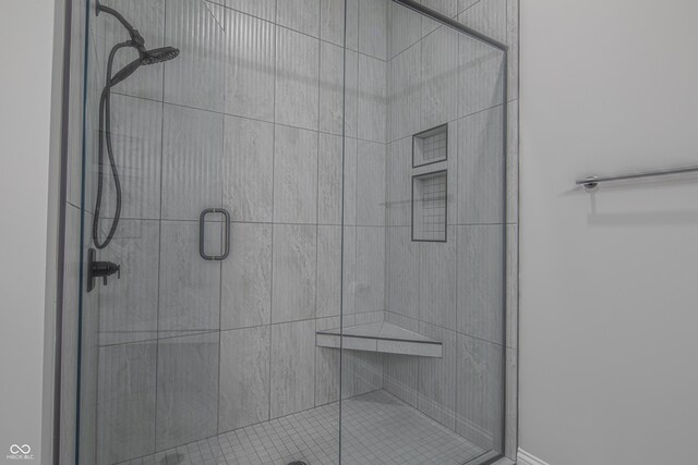 bathroom featuring a shower with shower door