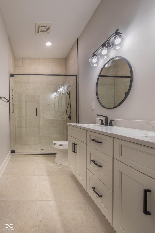 bathroom featuring a shower with shower door, toilet, tile patterned flooring, and vanity