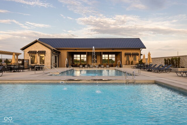 view of pool featuring pool water feature and a patio area