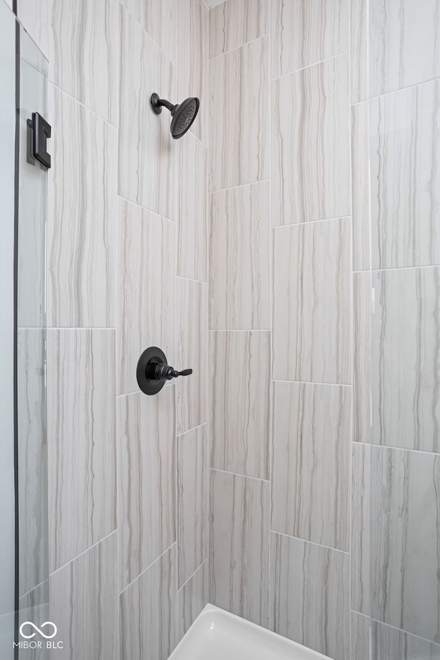 bathroom with a tile shower