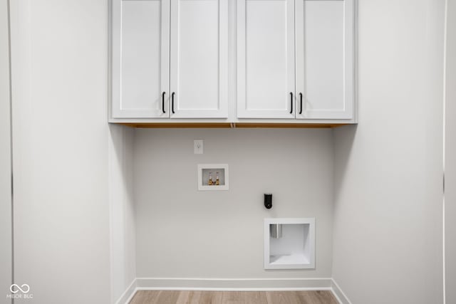 laundry room featuring cabinets, hookup for a washing machine, light hardwood / wood-style flooring, and electric dryer hookup