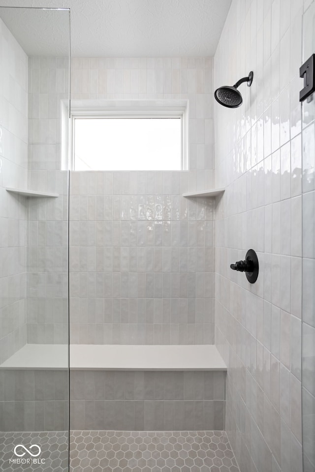 bathroom with tiled shower