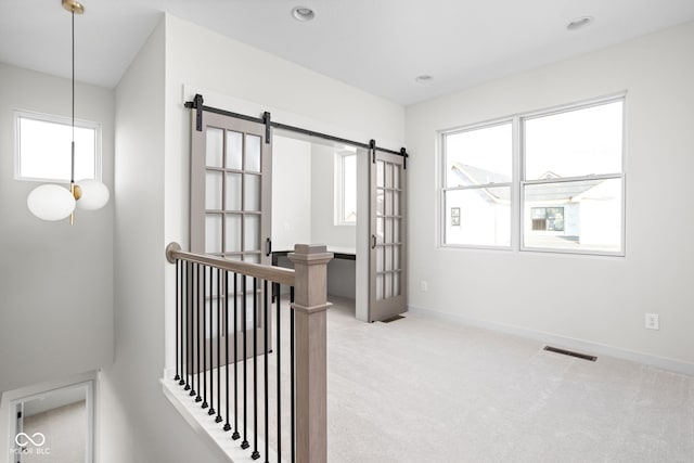 interior space featuring carpet and a barn door