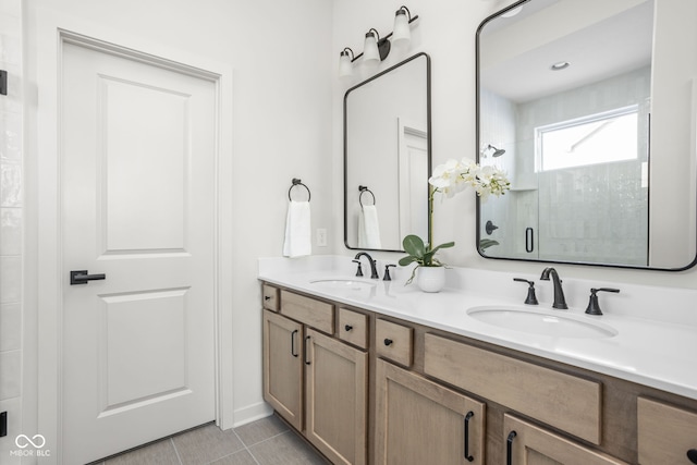 bathroom with walk in shower, vanity, and tile patterned flooring