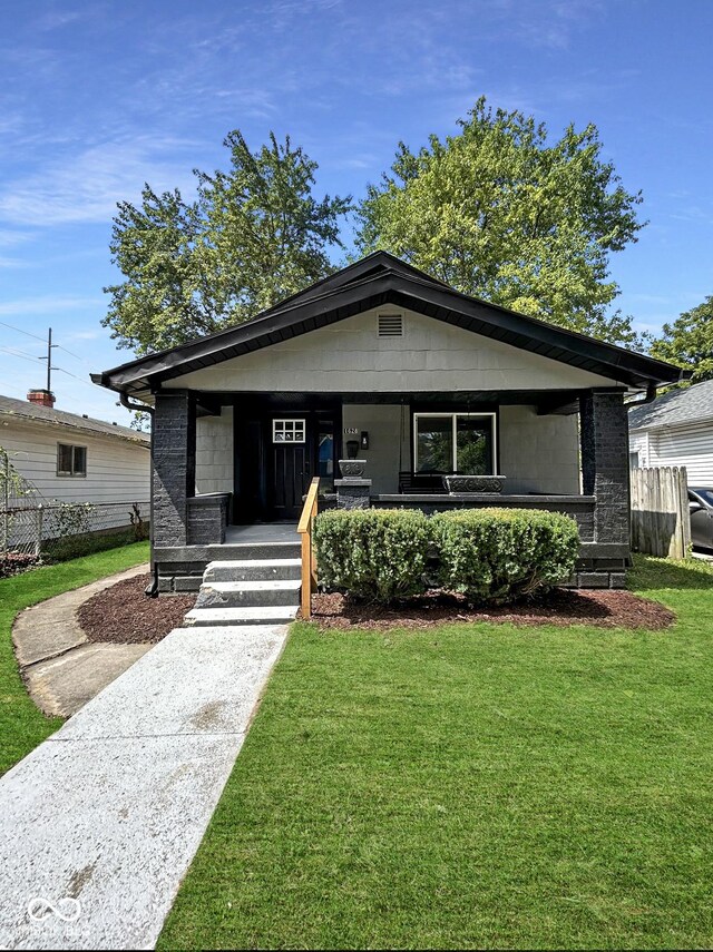 view of front facade with a front yard and a porch