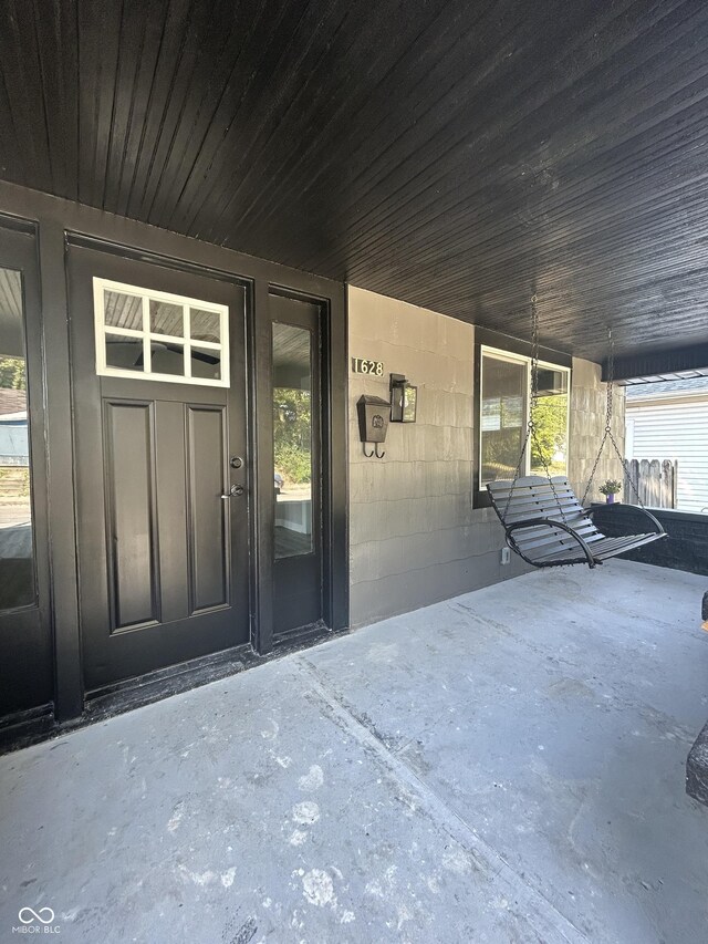 view of exterior entry featuring covered porch