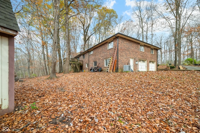 view of home's exterior featuring a garage and central AC unit