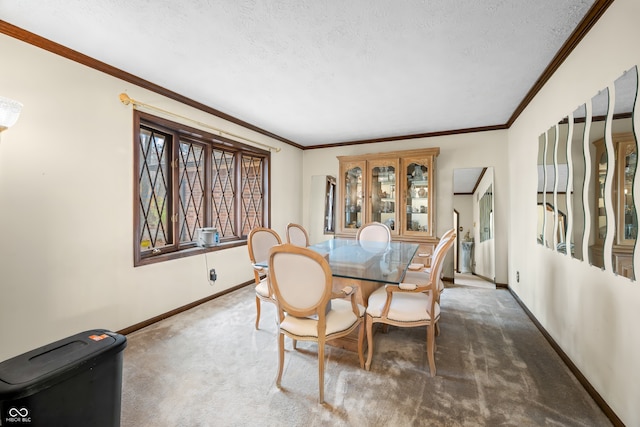 dining area featuring dark carpet, ornamental molding, and a textured ceiling