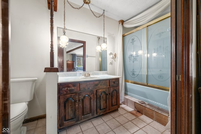 full bathroom with vanity, a textured ceiling, shower / bath combination with glass door, tile patterned flooring, and toilet