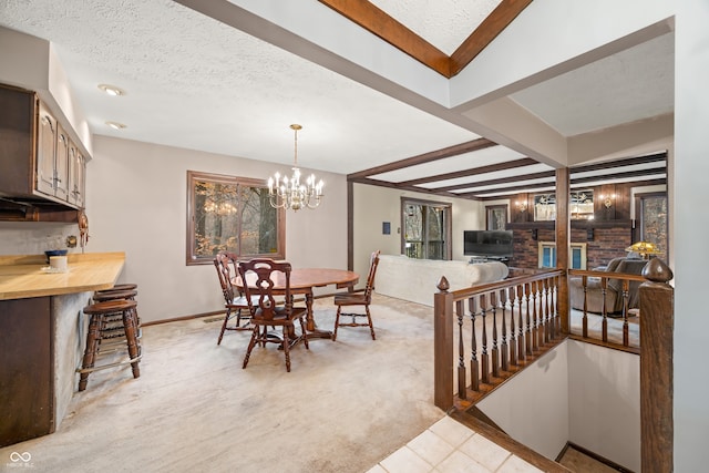 carpeted dining room with beam ceiling, a textured ceiling, and a notable chandelier