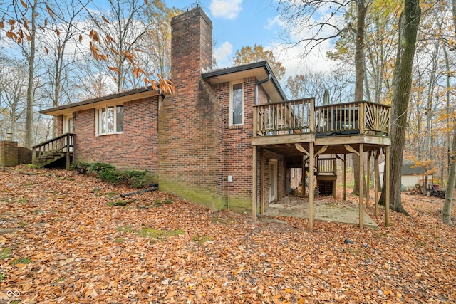 back of property featuring a patio area and a deck