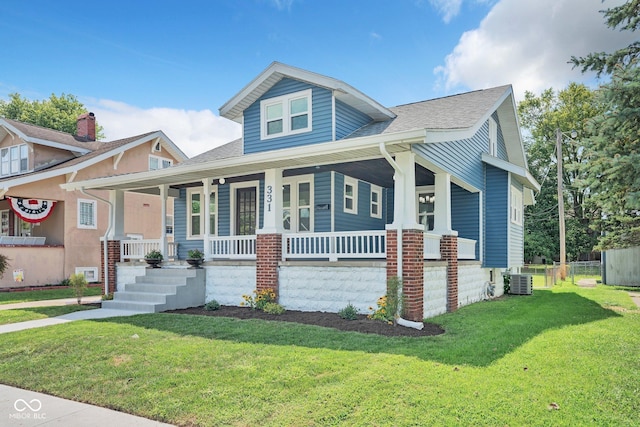 view of front of property with central AC unit, a front yard, and a porch