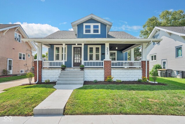 bungalow-style house featuring a porch and a front lawn